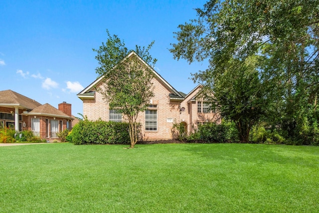 exterior space with a yard and brick siding