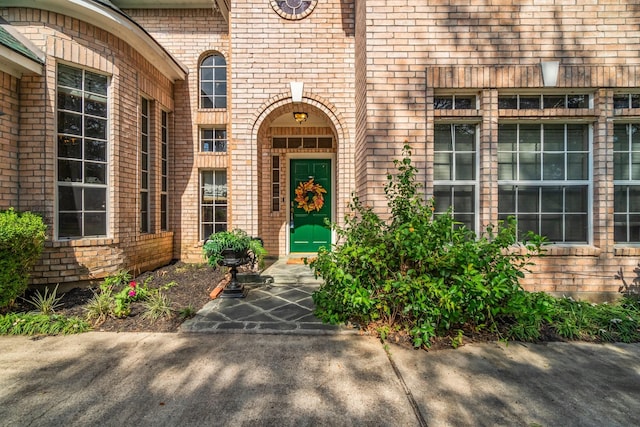 property entrance featuring brick siding