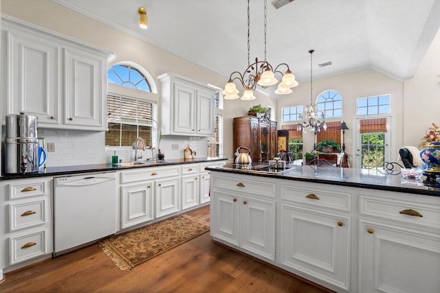 kitchen featuring hanging light fixtures, white cabinetry, a sink, a chandelier, and dishwasher