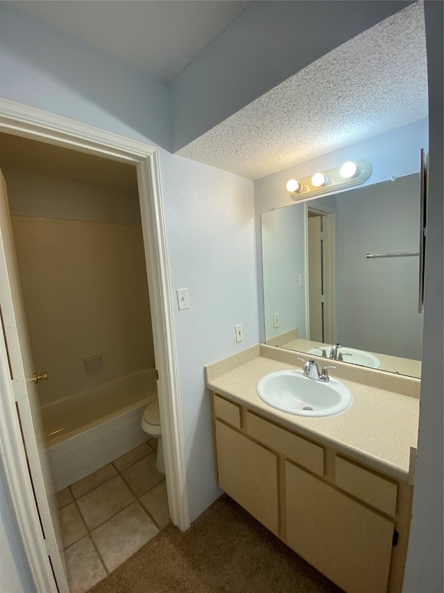 bathroom featuring tile patterned floors, a textured ceiling, vanity, and toilet