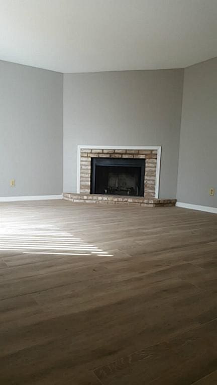 unfurnished living room with wood-type flooring