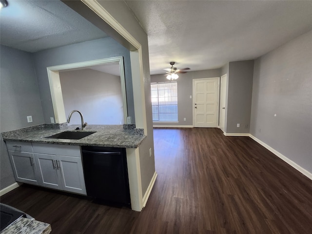 kitchen featuring ceiling fan, black dishwasher, sink, and dark wood-type flooring