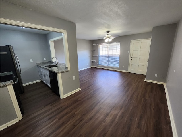 interior space featuring sink, ceiling fan, a textured ceiling, and dark hardwood / wood-style floors