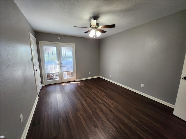 spare room with french doors, a ceiling fan, baseboards, and dark wood-style flooring