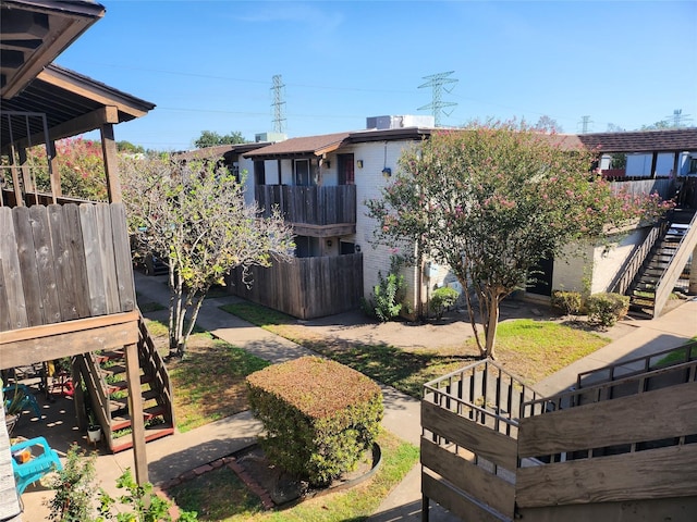 view of yard with stairway and fence