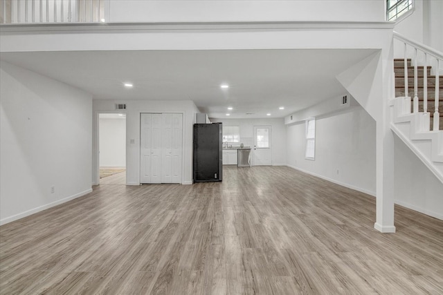 unfurnished living room with light hardwood / wood-style floors and a wealth of natural light