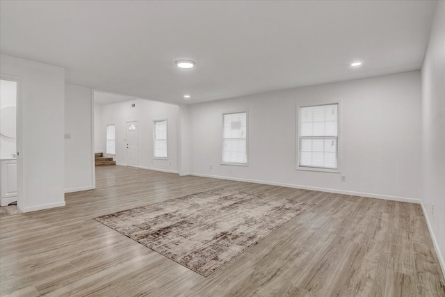 unfurnished living room with light hardwood / wood-style flooring