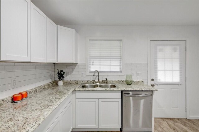 kitchen featuring white cabinets, dishwasher, a healthy amount of sunlight, and sink