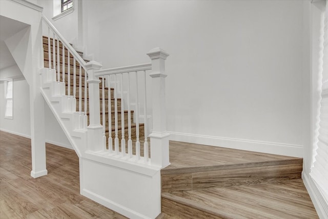 stairs featuring hardwood / wood-style floors