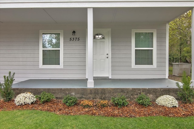 view of exterior entry with a porch