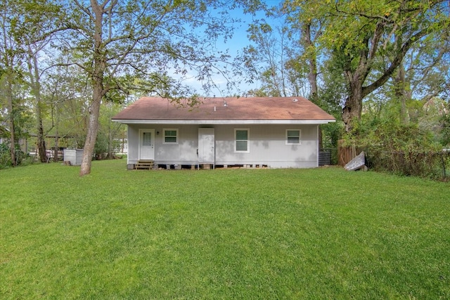 rear view of property featuring a yard