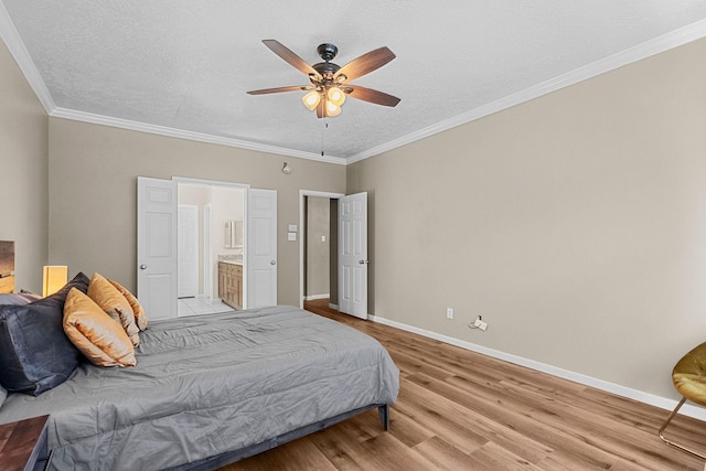 bedroom featuring ornamental molding, baseboards, a textured ceiling, and light wood finished floors