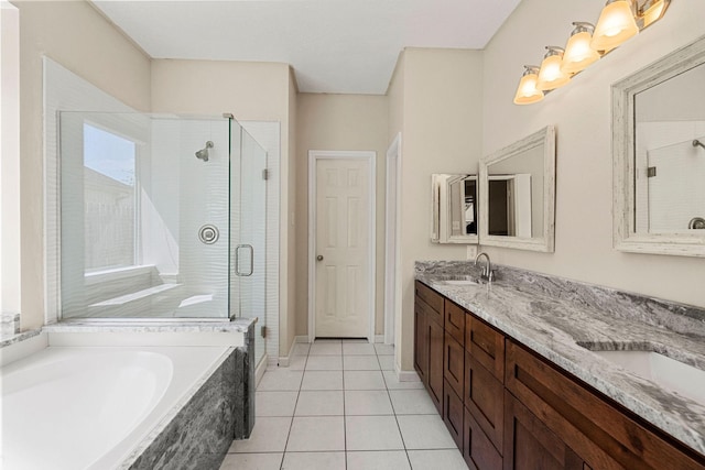 bathroom with a bath, a stall shower, tile patterned flooring, and a sink