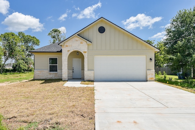 view of front of home with a garage and a front lawn