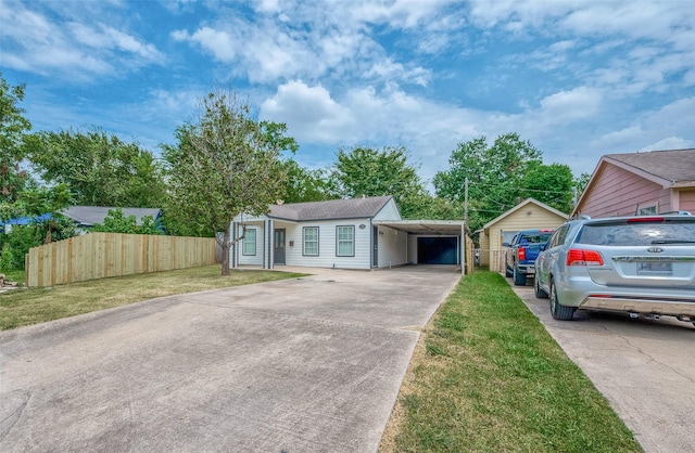 view of front of property with a front yard, fence, and driveway