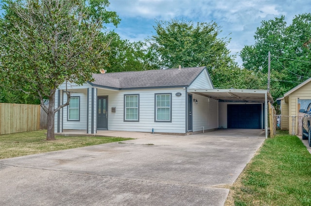 ranch-style house with a front lawn, a carport, and a garage