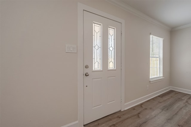 foyer with hardwood / wood-style floors and ornamental molding