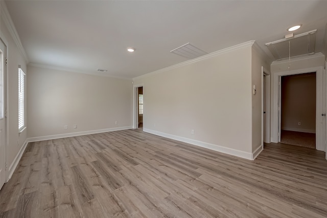 empty room with light hardwood / wood-style flooring and crown molding