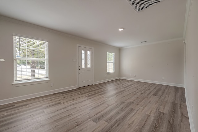 entrance foyer featuring crown molding and hardwood / wood-style floors