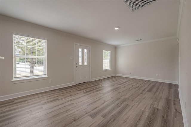 entrance foyer with wood finished floors, baseboards, and ornamental molding