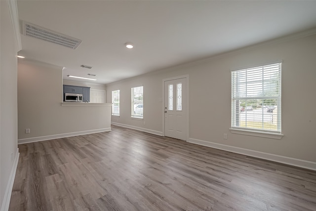 foyer featuring crown molding and wood-type flooring