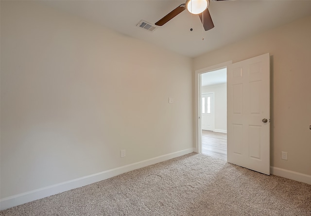 carpeted empty room with ceiling fan