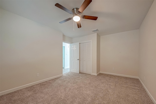 unfurnished room with light carpet, visible vents, ceiling fan, and baseboards