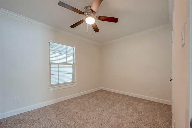 carpeted empty room featuring crown molding, a ceiling fan, and baseboards