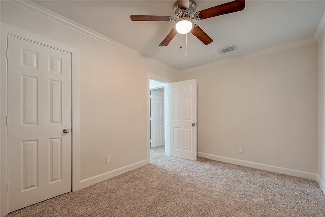 unfurnished bedroom featuring ceiling fan, light carpet, and crown molding