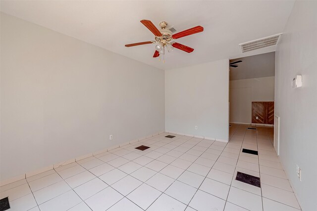 spare room featuring light tile patterned floors, visible vents, and a ceiling fan