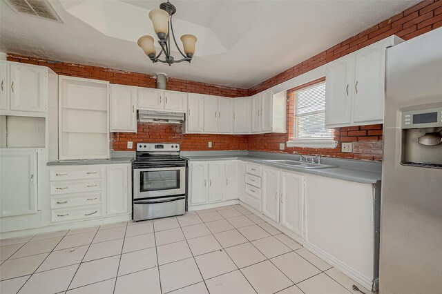 kitchen with under cabinet range hood, brick wall, stainless steel appliances, a sink, and visible vents