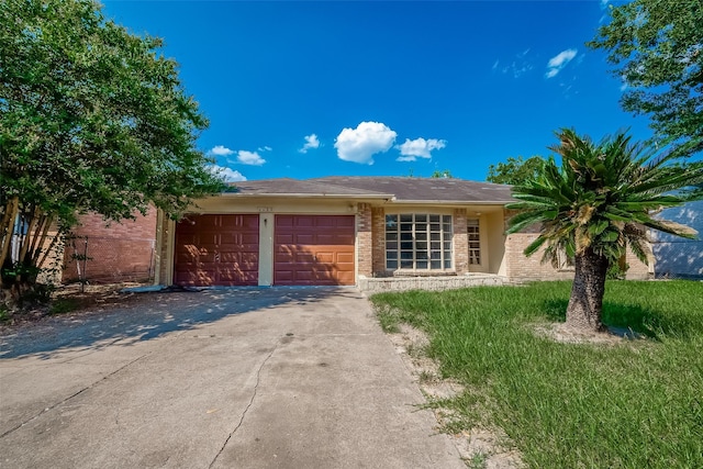 ranch-style home with a garage, brick siding, and driveway