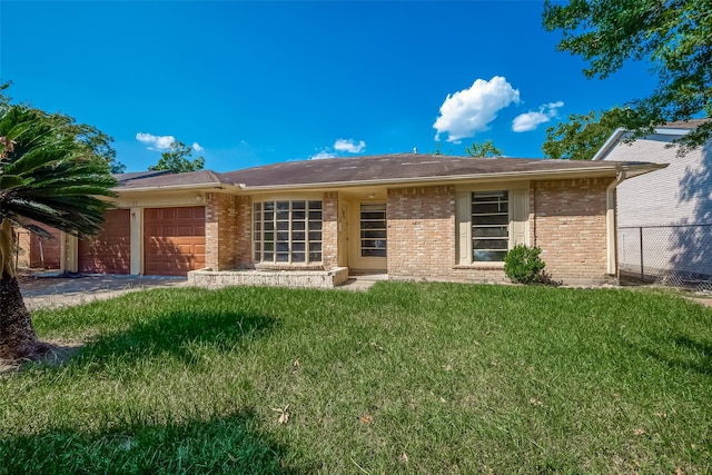 view of front of home with a front yard and a garage