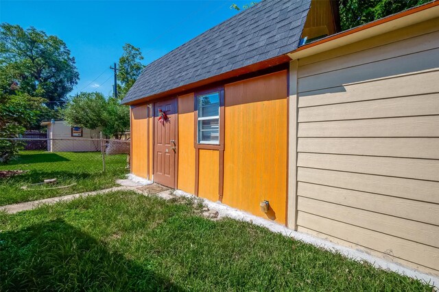 view of outbuilding featuring fence