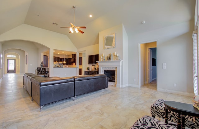 tiled living room featuring ceiling fan and lofted ceiling