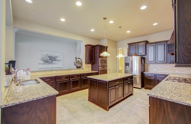 kitchen with decorative backsplash, light stone countertops, sink, kitchen peninsula, and stainless steel appliances