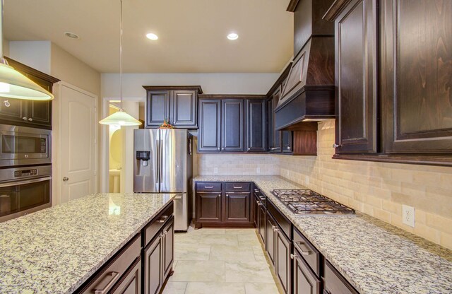 kitchen featuring appliances with stainless steel finishes, hanging light fixtures, custom exhaust hood, and backsplash