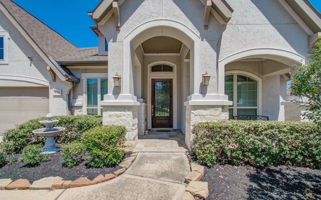 view of exterior entry featuring a garage