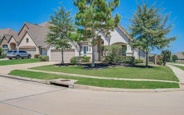 view of front of home featuring a garage and a front yard