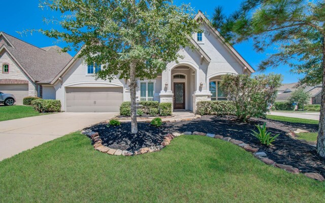 view of front of house featuring a garage and a front lawn