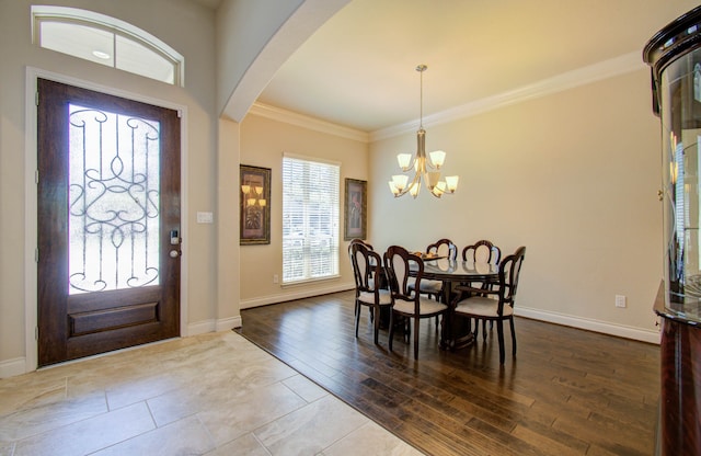 foyer entrance featuring a notable chandelier, crown molding, and hardwood / wood-style flooring