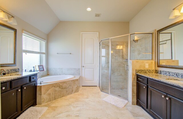 bathroom with tile patterned flooring, separate shower and tub, vanity, and lofted ceiling