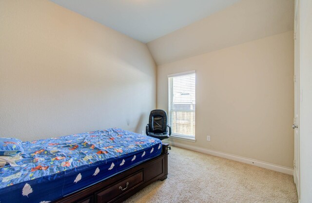 bedroom featuring lofted ceiling and light colored carpet