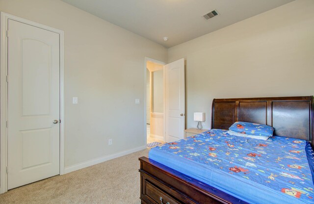 bedroom featuring light carpet