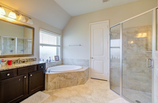 bathroom with plus walk in shower, vaulted ceiling, tile patterned flooring, and vanity