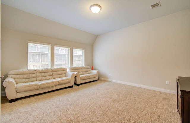 carpeted living room with lofted ceiling