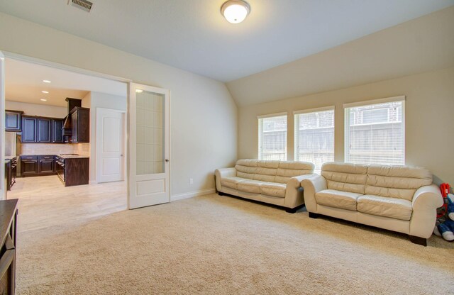 carpeted living room with vaulted ceiling