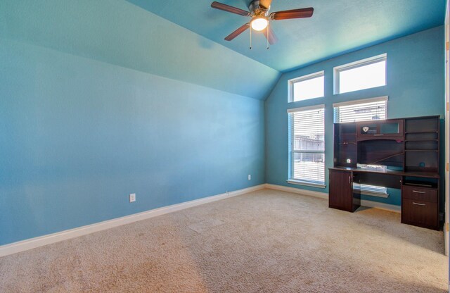 unfurnished office with a wealth of natural light, lofted ceiling, and light carpet