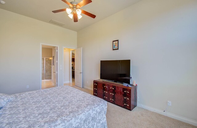 carpeted bedroom featuring ceiling fan and ensuite bathroom