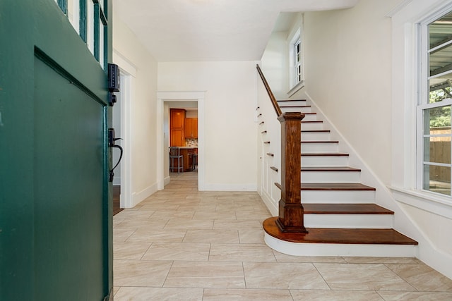 staircase featuring baseboards